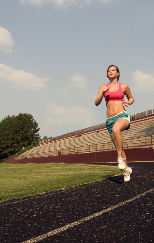 15317-a-healthy-young-woman-running-outdoors-on-a-track-pv