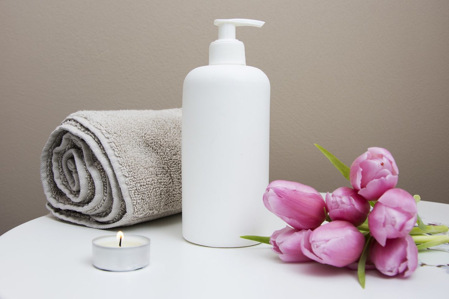 Pink flowers on a white table with towel